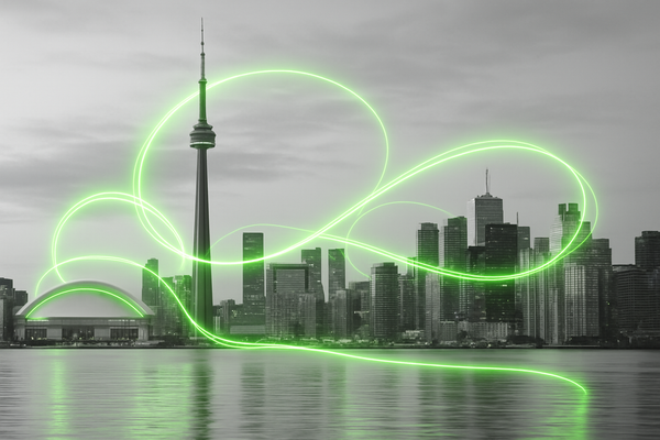 A lighter grayscale photograph of Toronto skyline with the CN Tower and buildings highlighted by flowing green light effects that loop around the city like electrical currents