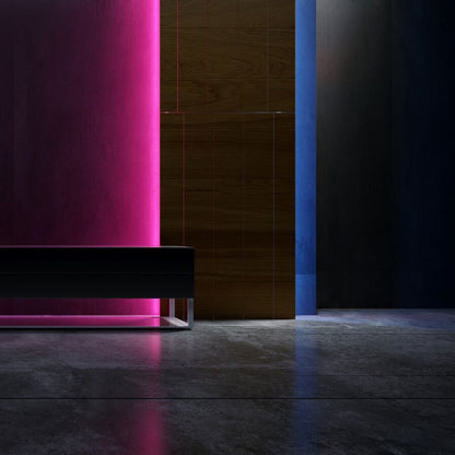 Modern black sofa against a dark wall with rgb neon light