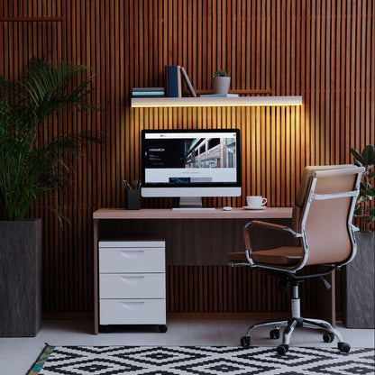 Modern office setup with a desk, chair, and computer monitor against a wooden paneled wall.